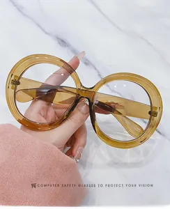 Detail of oversized amber resin round frame computer glasses with blue light blocking lenses