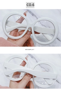 Detail view of oversized white round frames showing the 45-degree angle display
