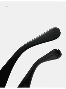 Detail of curved black sunglasses legs with polished finish and smooth rounded ends