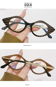 Detail view of cat eye glasses frames with orange stripes and metal temple hinges