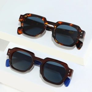 Vintage rectangle sunglasses with tortoiseshell and brown frames on geometric display