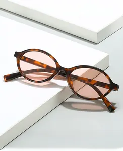 Close-up of retro tortoiseshell oval frame with light orange lenses and smooth texture