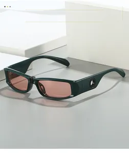 Detail view of dark green rectangle sunglasses with unique temple hollow-out design
