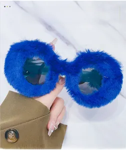 Detailed view of round sunglasses featuring fluffy high-saturation blue plush frames