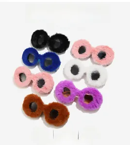 Detailed view of colorful plush-trimmed round sunglasses in seven fashion shades