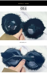 Detailed views of stylish black oversized round sunglasses featuring plush fur trim accents