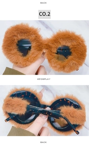 Detail view of round sunglasses with orange plush trim and tortoiseshell temples