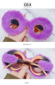 Detail view of purple plush faux fur round sunglasses with orange gradient lenses