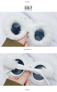Detail view showing white faux fur trim and circular frames of these plush sunglasses