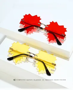 Detail view of rimless leaf shaped sunglasses with gold metal frame in red and yellow