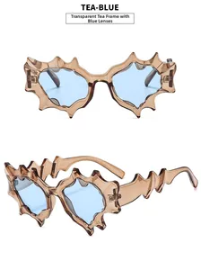 Detail view of tea-blue Y2K sunglasses with irregular jagged frames and blue lenses