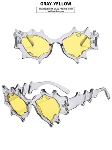 Detail of Y2K futuristic sunglasses with grey irregular frame and yellow lenses