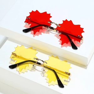Frameless maple leaf sunglasses in red and yellow with golden metal bridge and black temples