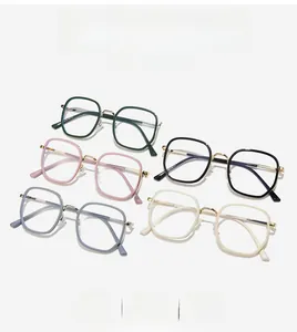 Detail view of five trendy square eyeglass frames in green, pink, and grey colors