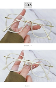 Detail view of square cream eyeglass frames with gold bridge and metal temples