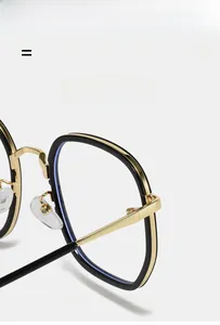 Detail of super elastic metal hinges on square black and gold glasses frame