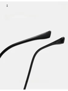Detail of sleek black curved mirror legs on minimalist square eyeglass frames