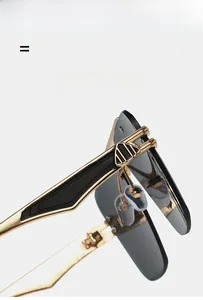 Detailed close-up of engraved gold metal hinge and adjustable nose pads on rimless sunglasses