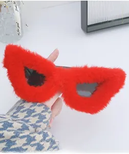Detailed view of red plush faux fur cat eye sunglasses frames with dark lenses