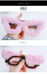 Detailed view of creative cat eye sunglasses with pink faux fur trim and tortoiseshell arms