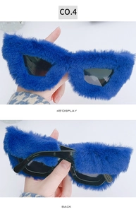 Detail of dark blue plush faux fur frame on creative cat-eye sunglasses from side angle
