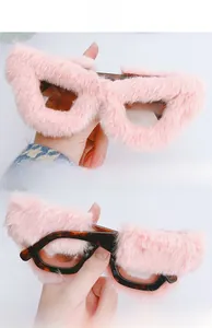 Detailed view of pink plush fur trimming on cat eye sunglasses with tortoise frame