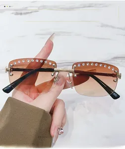 Close-up of gradient brown rimless sunglasses with rhinestone trim and metal temples