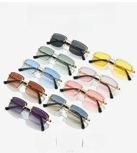 Detail of rimless sunglasses with gradient lenses and rhinestone trim in multiple colors