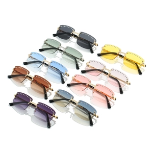 Frameless rhinestone sunglasses set with crystal accents and colorful gradient lenses