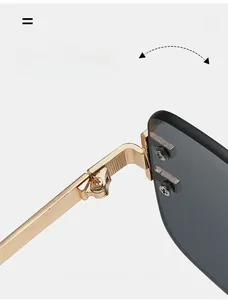 Detail of durable gold metal hinges and dark lenses on rimless square sunglasses