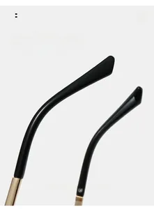 Detail of curved eyeglass legs with golden metal hinges for a comfortable fit