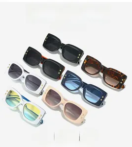 Detail of square sunglasses collection with gold star accents and assorted colorful frames