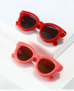 Detailed view of red and pink inflatable puffed oval sunglasses with golden metal accents