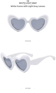 Gros plan de lunettes de soleil blanches en forme de cœur avec verres gris clair et design puffy