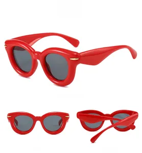 Three-angle view of red chunky oval puffy sunglasses with gold hinge detail