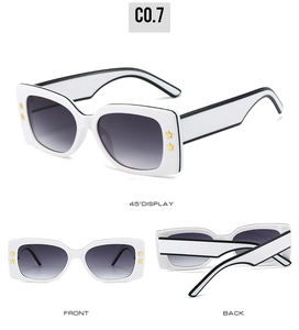 Detail view of square white sunglasses with black outlines and gold star accents