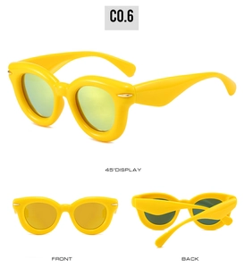 Detailed views of yellow oval puffer sunglasses with thick frames and golden metal accents