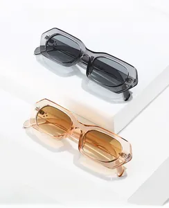 Detailed view of geometric thick frame sunglasses displayed on white platforms