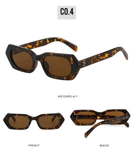 Detail view of tortoiseshell polygon sunglasses with wide frames and metallic rivet hinges