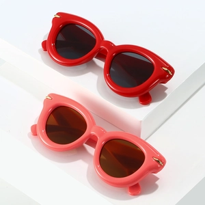 Chic puffy inflatable style oval sunglasses in vibrant red and pink with gold wing accents