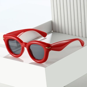 Fashionable red puffed sunglasses with oval frames and dark lenses for men and women