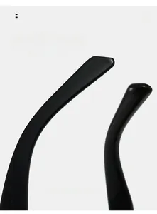 Macro shot of glossy black curved temple arms on stylish narrow frame sunglasses