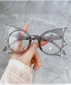 Close-up of bat-shaped grey frames with hand-set rhinestones and star accents