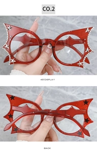 Detail of red bat-wing shaped frames with hand-set rhinestones and silver stars