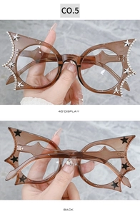 Detail of bat-wing shaped glasses frames with sparkling rhinestones and star accents