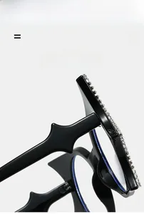 Close-up of bat-shaped glasses with rhinestones and zig-zag temples on a light background