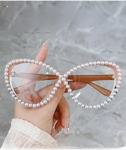 Detail of pink cat eye frames with white pearls and infinity shape design