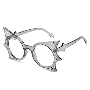 Cat eye bat shaped eyewear with stars and rhinestones in translucent grey frames