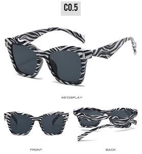 Cat eye sunglasses with zebra stripes, dark lenses, and gold metal accents in three views