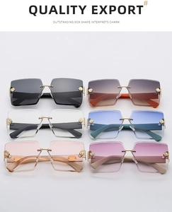 Flat lay of frameless gradient sunglasses featuring elegant golden rose temple details
